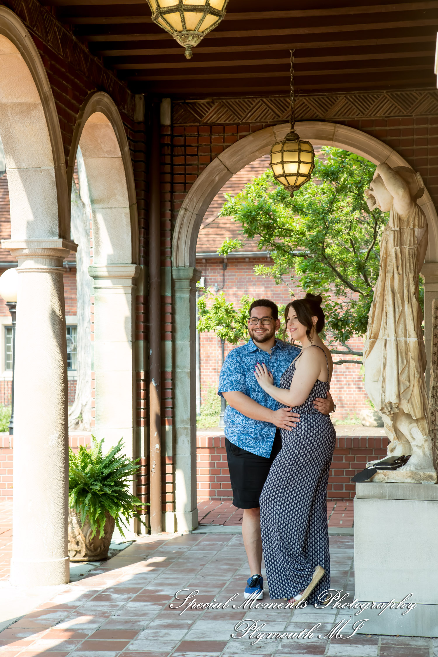 Creative off-camera flash portrait of a newly engaged couple in a shaded archway at Cranbrook House & Gardens.