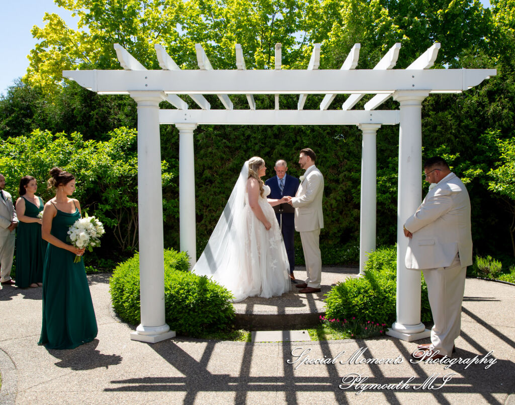 Kristine and Robert exchange vows during an outdoor wedding ceremony at the Bentley Banquet Center under bright sunlight. Kristine and Robert exchange vows during an outdoor wedding ceremony at the Bentley Banquet Center under bright sunlight.
