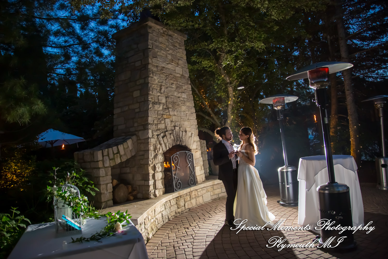 Newlyweds dancing their first dance at night on the twinkle-lit outdoor patio at Cafe Cortina in Farmington Hills Michigan.