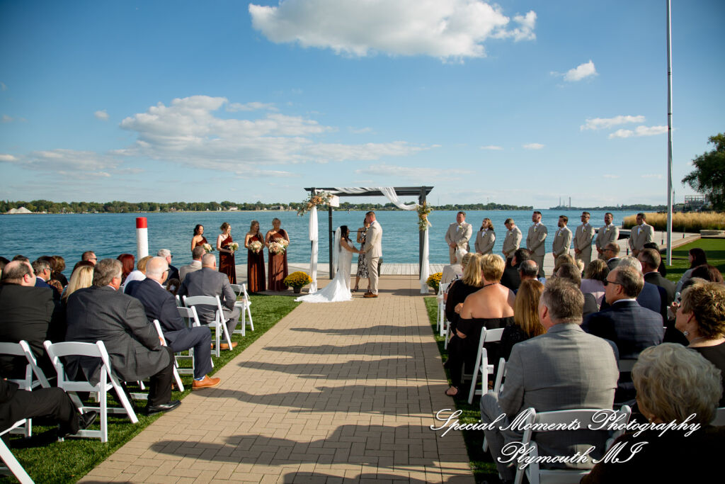 Caitlin and Chase exchange vows during their outdoor wedding ceremony on the Riverside Lawn at the historic St. Clair Inn.