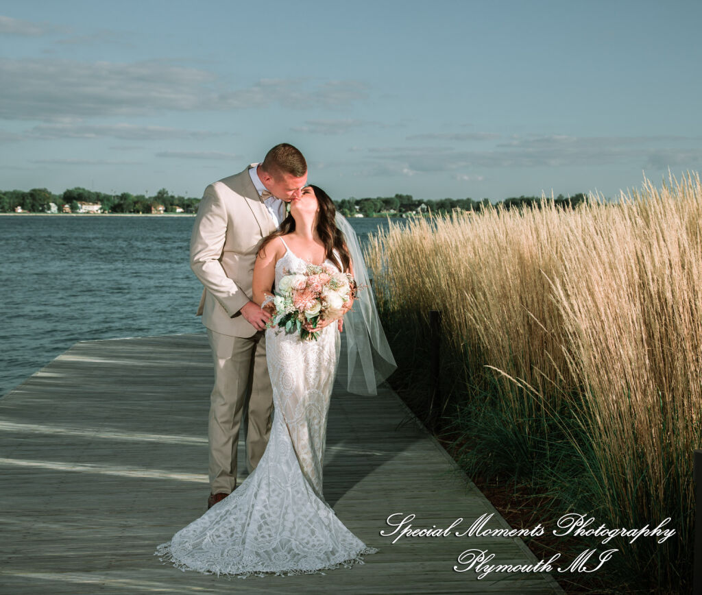 Caitlin and Chase pose for relaxed portraits along the historic riverfront boardwalk at the St. Clair Inn in Michigan.