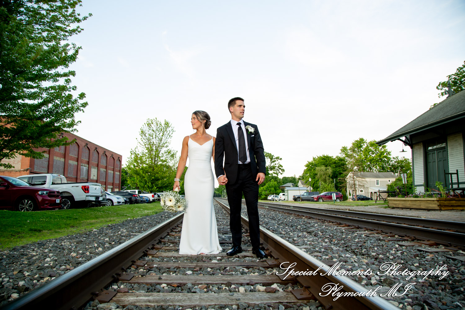 Ryli and Bennett posing for modern wedding portraits at The Collins at the Clocktower in Chelsea Michigan