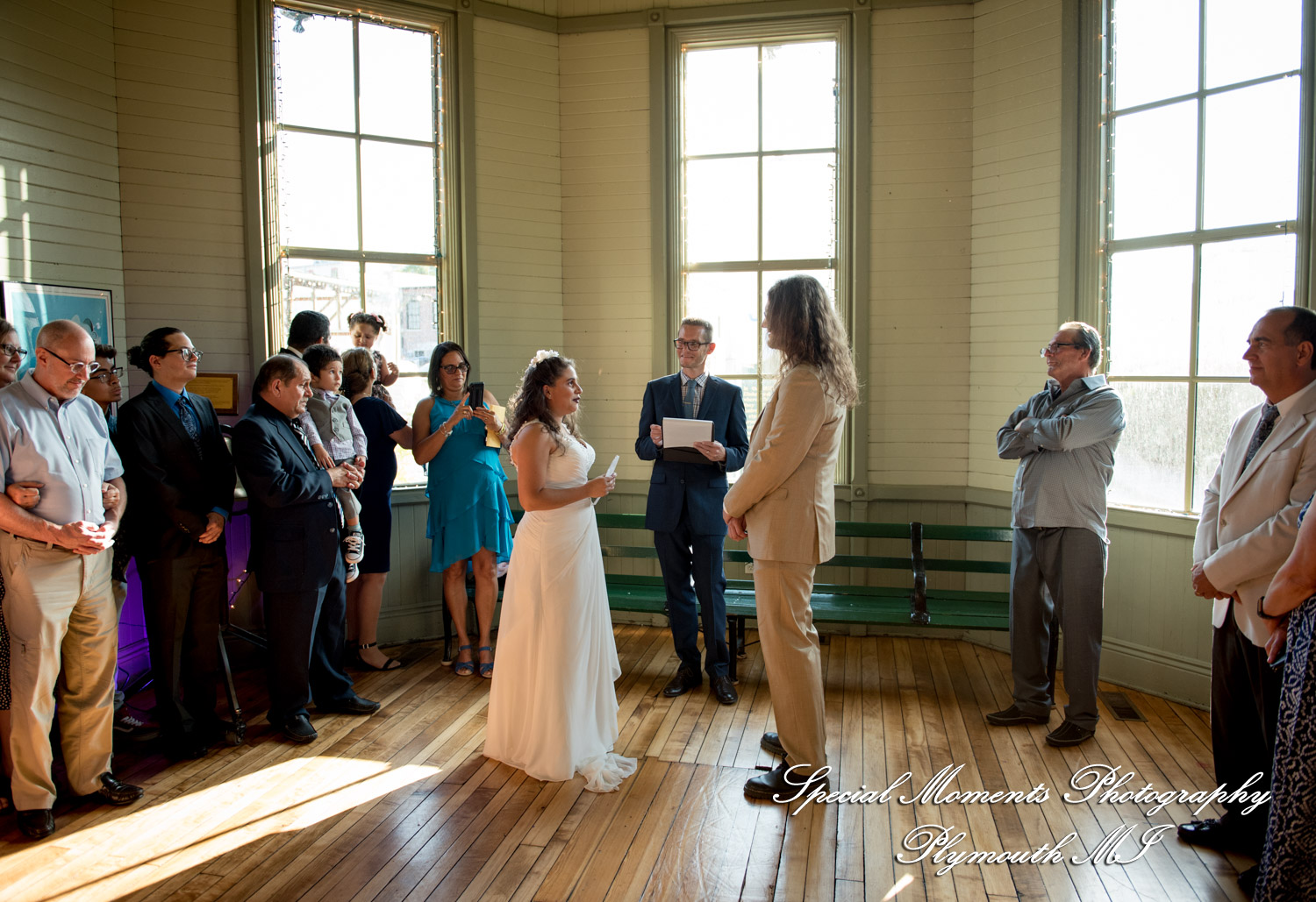 Lissy and Stephen exchange vows during their casual rustic wedding ceremony inside the historic Chelsea Train Depot in Chelsea MI.