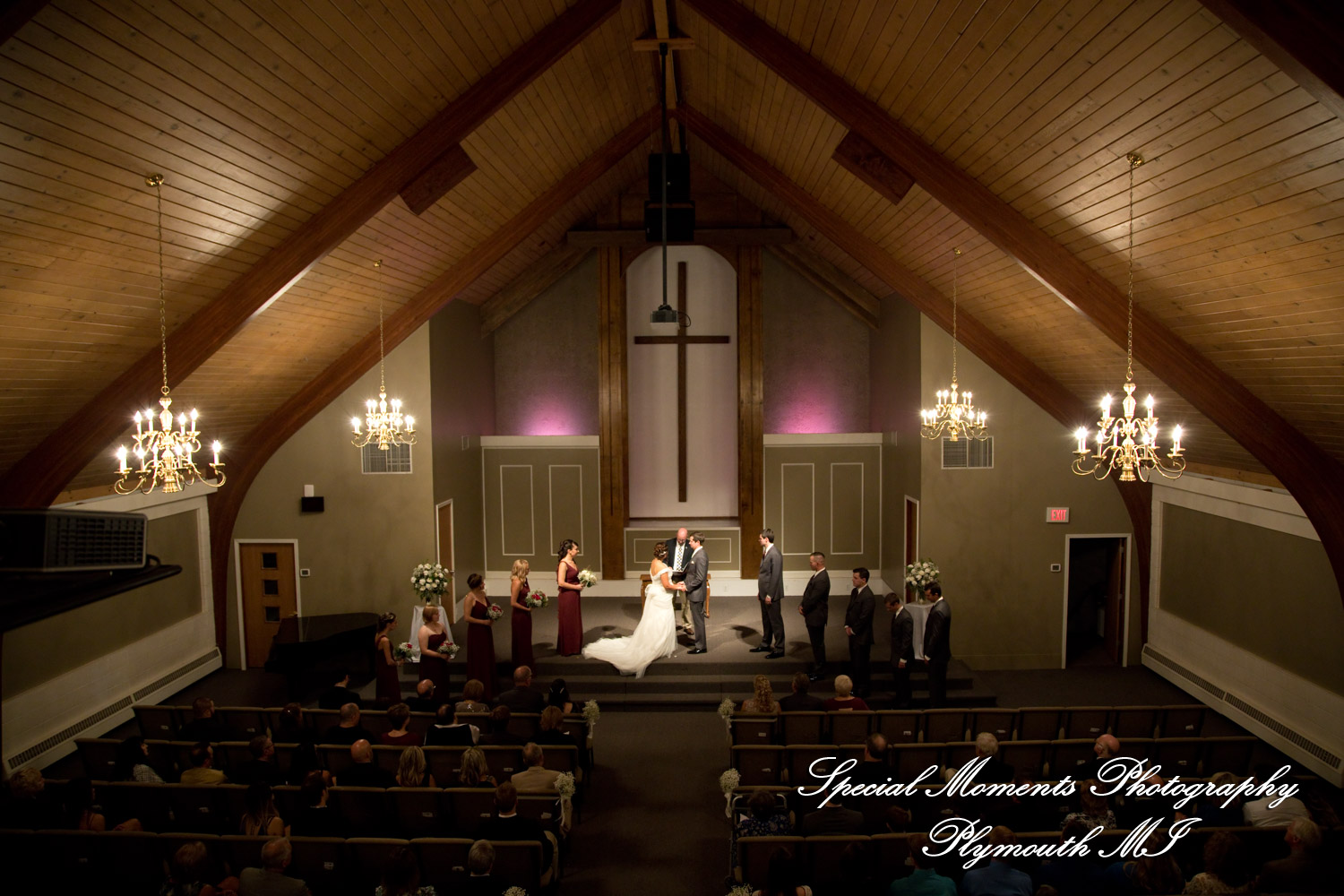 Jenna and Alex exchanging vows during their wedding ceremony at Woodside Bible Church in Plymouth Michigan