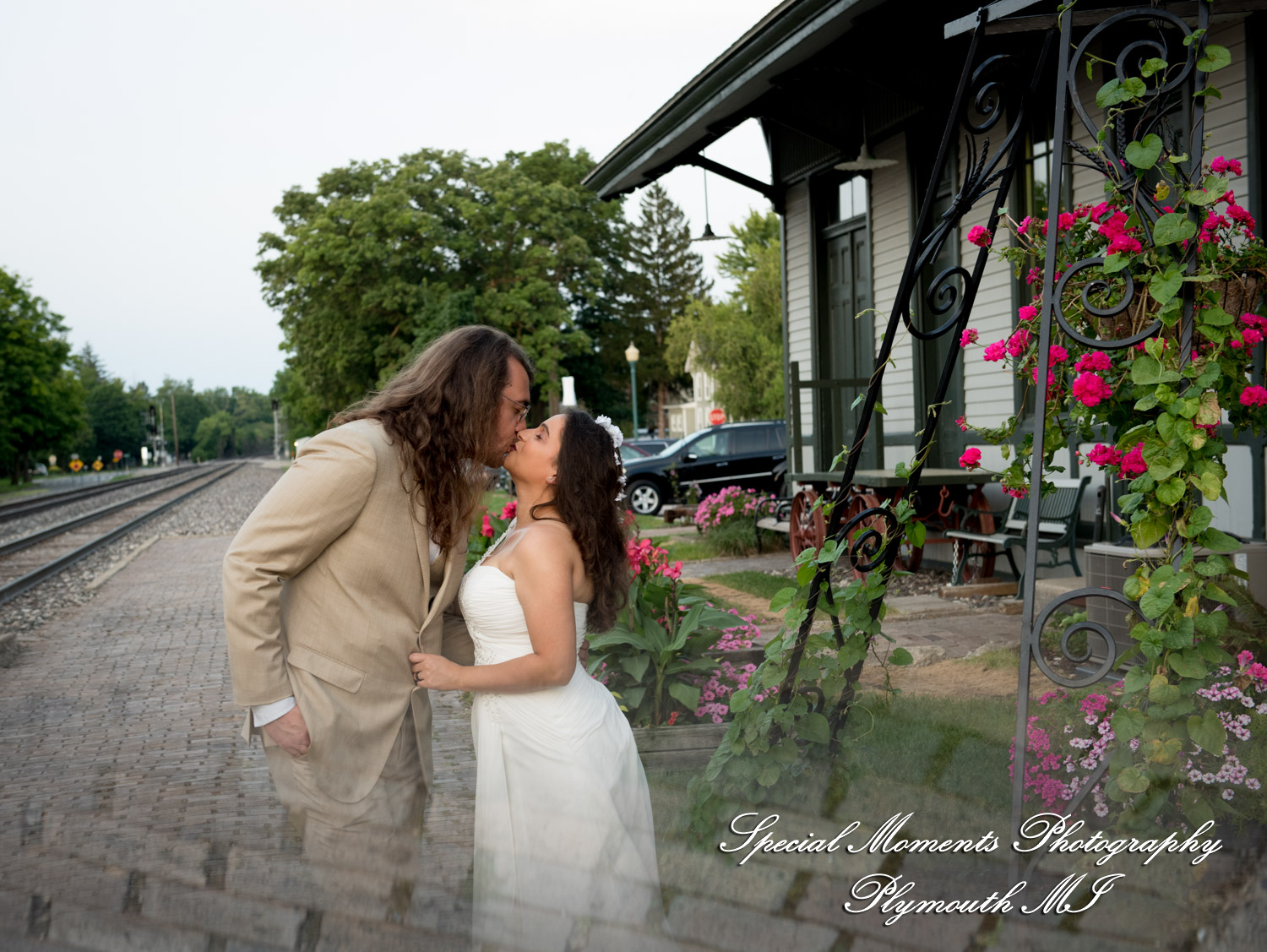 Bride Lissy and groom Stephen pose for relaxed portraits against the historic exterior of the Chelsea Train Depot.