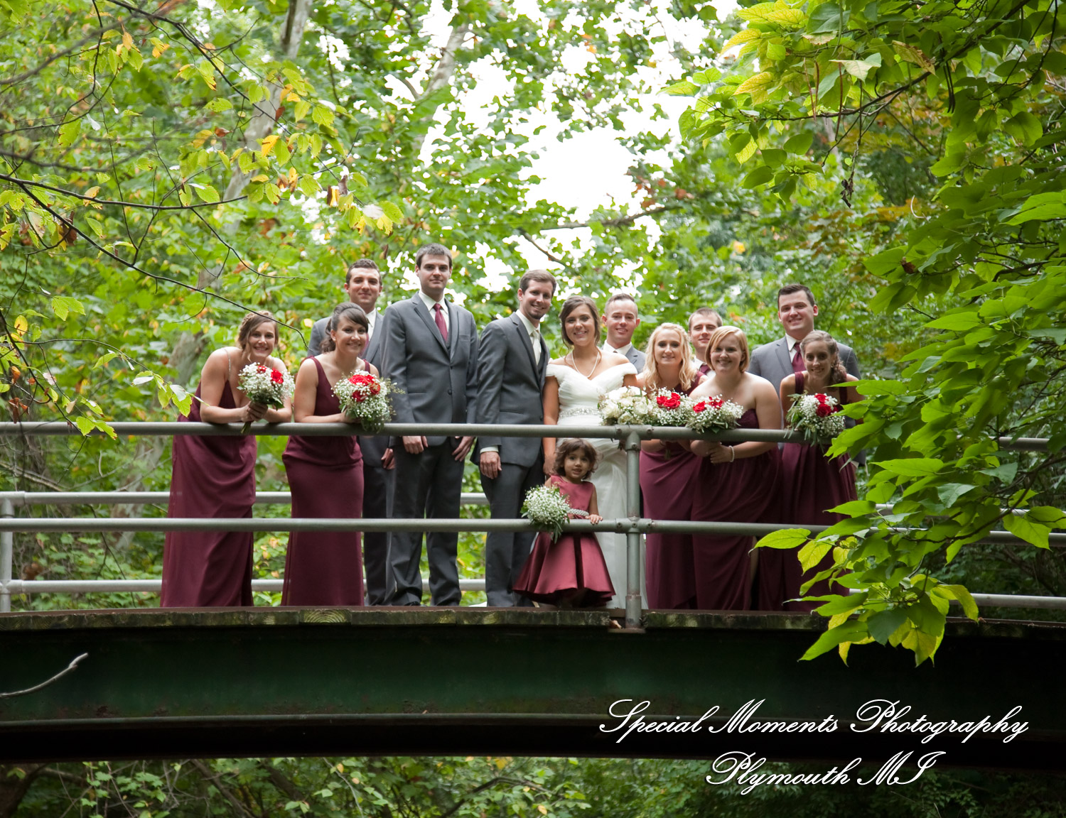 The bride and groom posing for romantic wedding portraits at Hines Park in Plymouth Michigan
