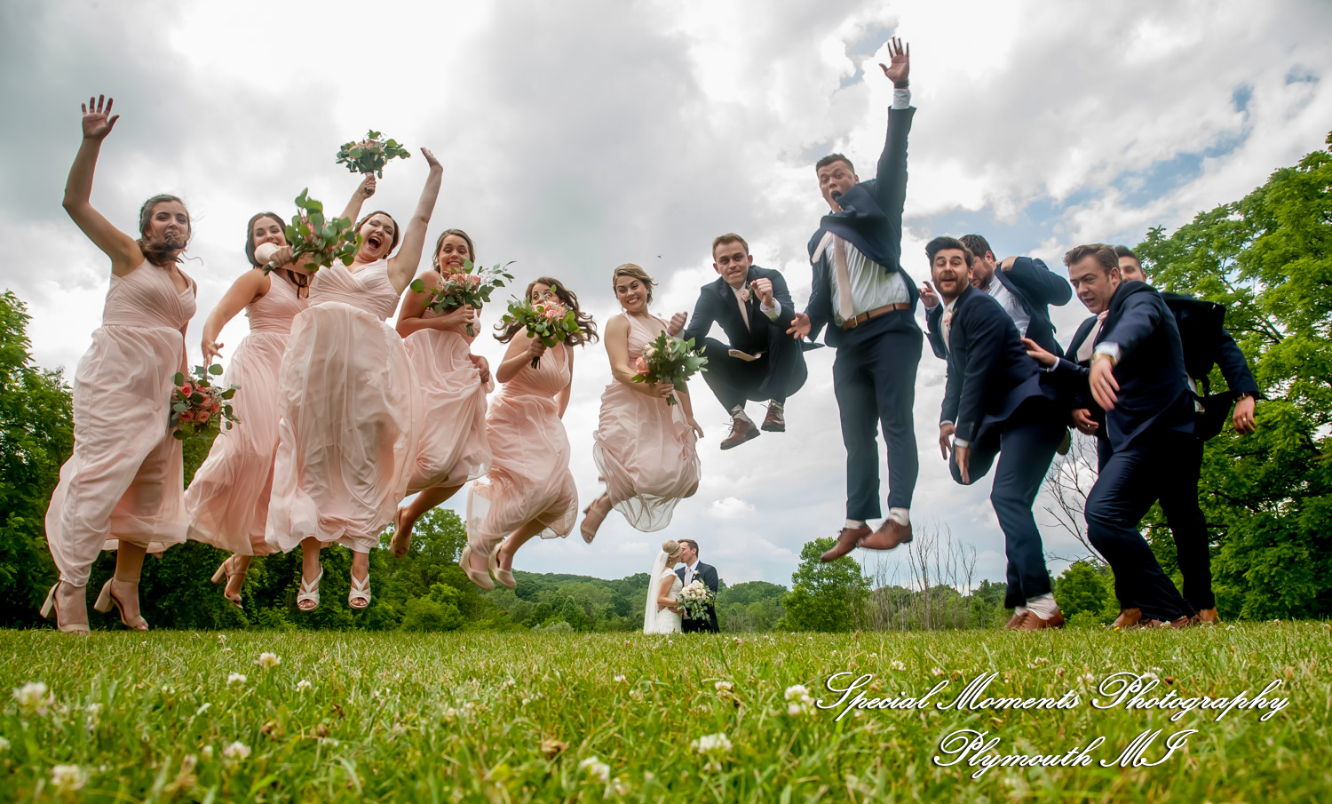 Meghan and Andrew share a fun moment under during their wedding portrait session at Heritage Park in Farmington Hills MI.