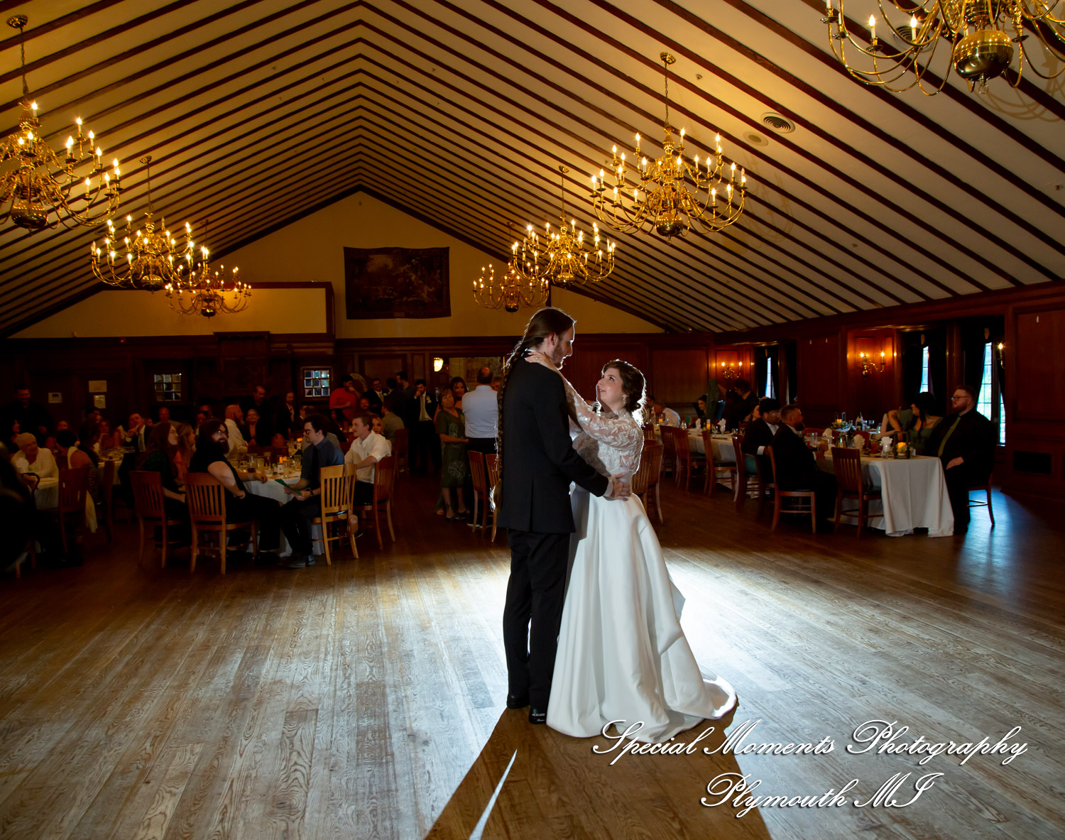 Maureen and Bailey share their formal first dance inside the elegant castle ballroom during their Lake Orion wedding reception.